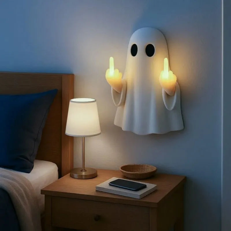White plastic ghost statue night lamp for Halloween decoration on a dark surface.