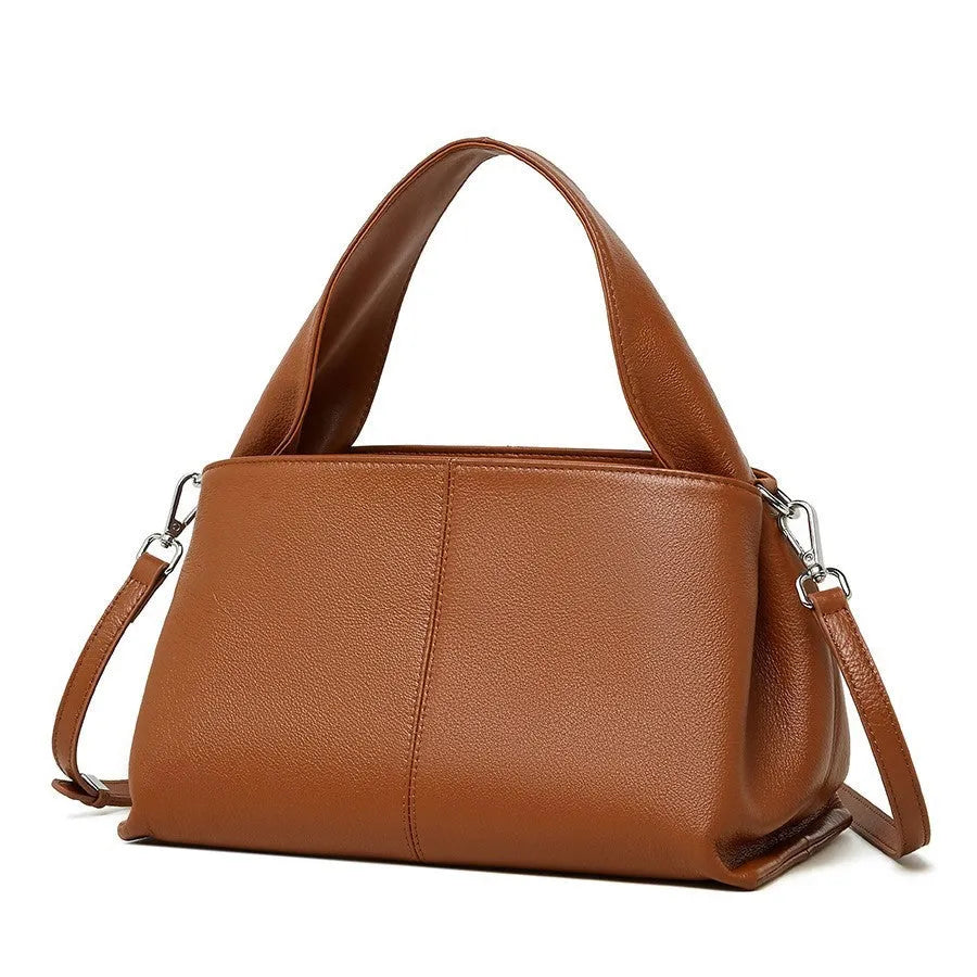 Women's genuine cowhide messenger bag with retro texture in horizontal square design showing shoulder straps and exterior pocket