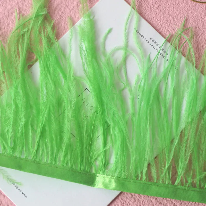 Decorative feather cloth strip in multiple colours including white, black, and mint green for DIY clothing and craft projects