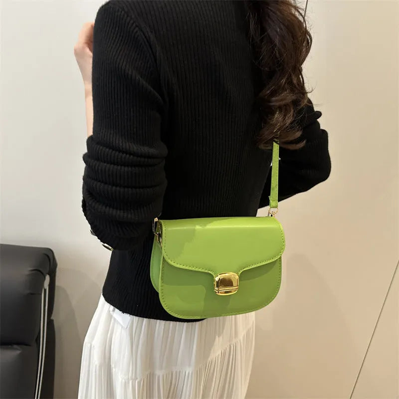 Simple PU leather women's handbag showing interior zipper coin compartment and phone pocket.