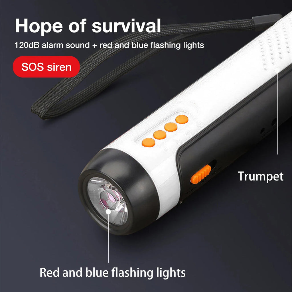 Orange emergency FM rechargeable alarm flashlight with hand crank on a dark outdoor background