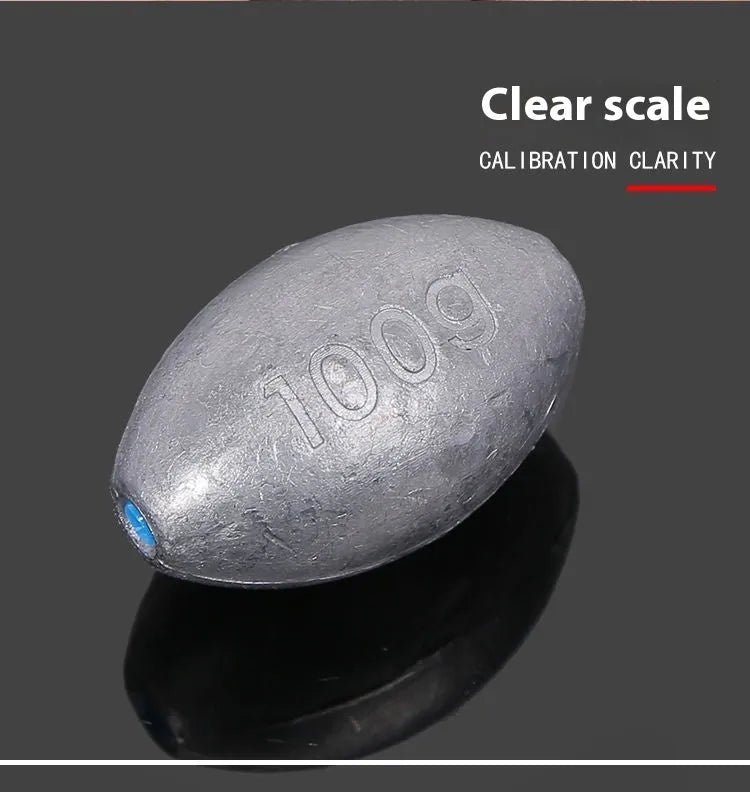 Close-up of a grey olive-shaped lead fishing sinker with scale texture, showing the central hole for rigging.