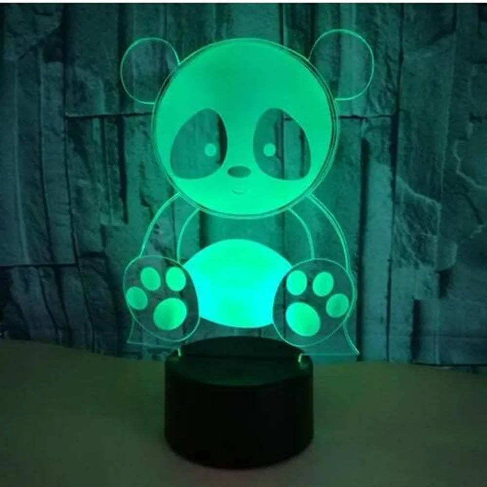 Panda-shaped acrylic night light with remote control on a table, showing multi-coloured LED illumination.