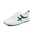 Women's white and black leather sneakers with elastic band closure and round toe