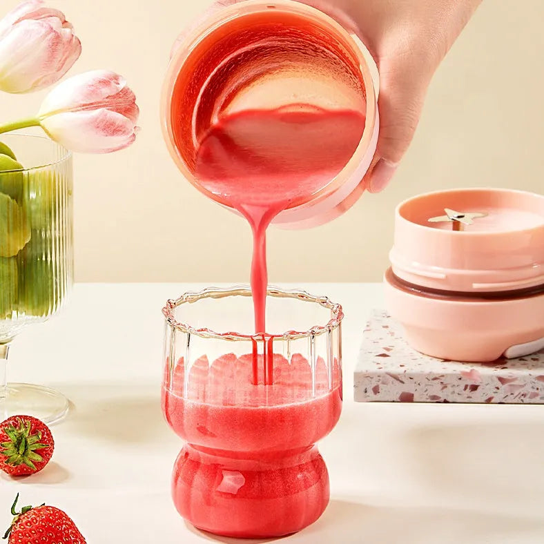 Portable purple blender cup with four stainless steel blades and a USB charging cable