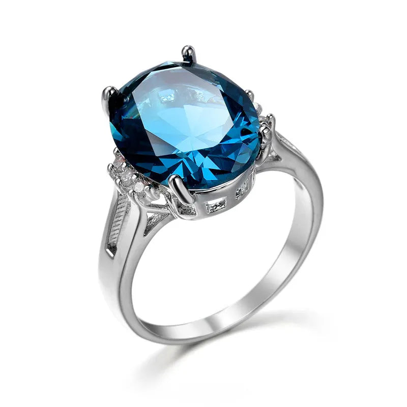 Geometric ellipse shaped zircon ring in electroplated blue black or medium blue copper, showing retro unisex style.