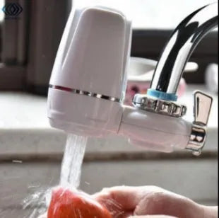 White kitchen faucet water filter with ceramic cartridge and universal thread adapters for tap mounting.