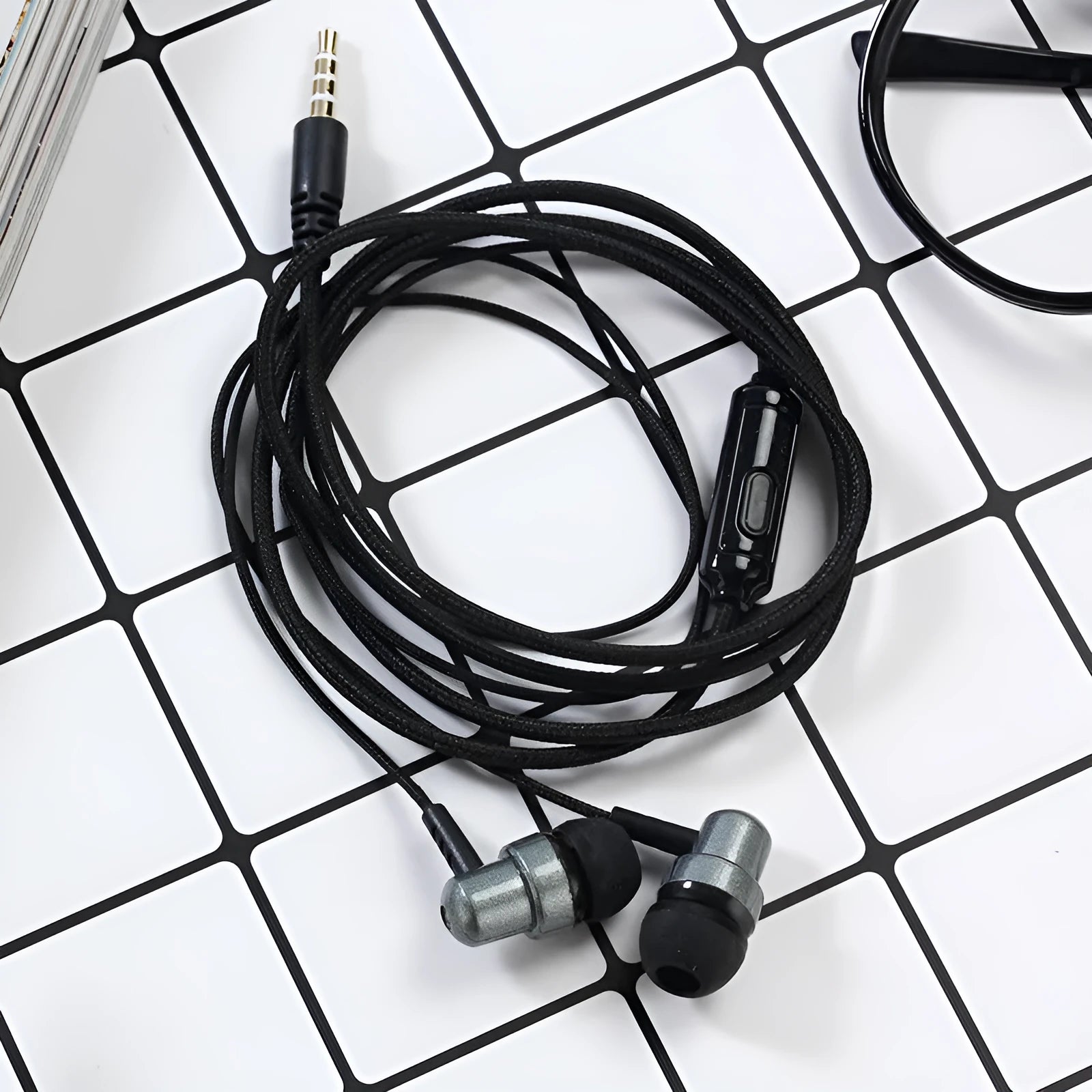 Direct-plug wired in-ear gaming headset with silicone earplugs, braided cable, and built-in microphone in black