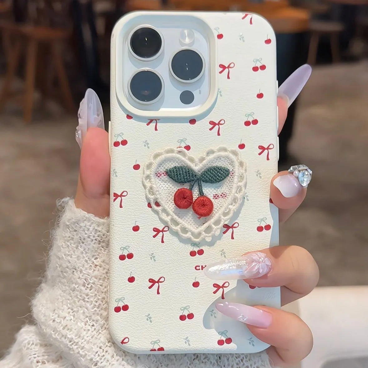 White lychee pattern iPhone case with three-dimensional embroidered cherry detail and anti-fall silicone cover