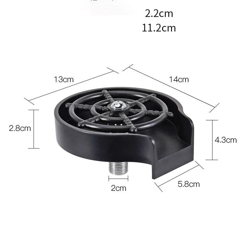 Black automatic cup washer with five-hole nozzle installed on a bar counter sink with a glass being rinsed