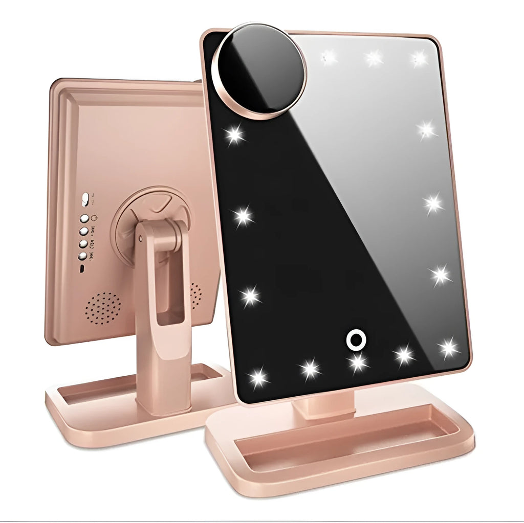 Pink touch screen LED makeup mirror with Bluetooth speaker and magnifying mirror on a table.