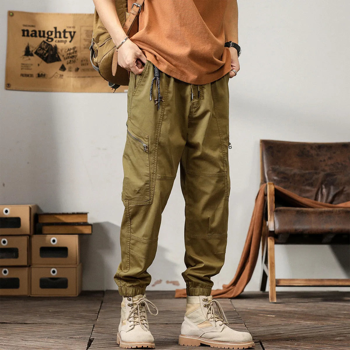Men's cotton harem pants with tapered ankle cuffs in black colour showing loose fit and zip fly closure