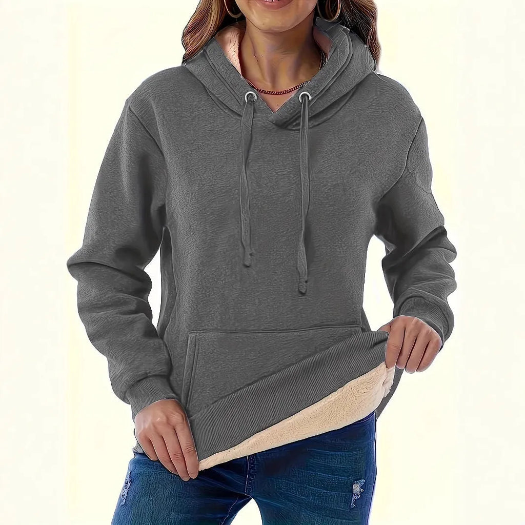 Women's loose fit hooded sweater in thick polyester fabric available in multiple colours.