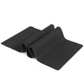 All black extra long desk mat with overlock stitched edges on a wooden desk