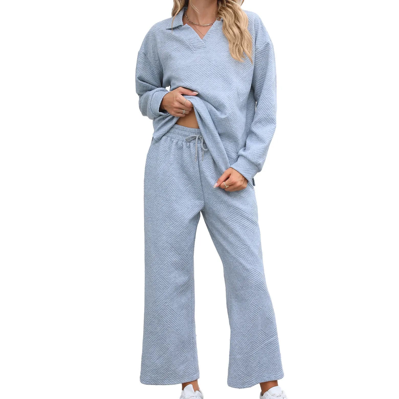 Women's solid colour knitted jacquard trouser suit with long sleeve top and cropped pants.
