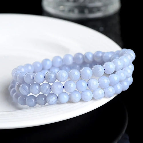 Blue agate beaded bracelet with three strands and a silver Ruyi-style clasp.