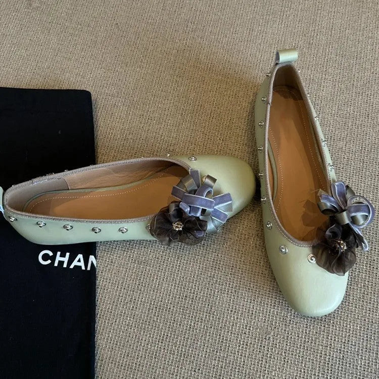 Women's silver Mary Jane loafers with flower rivets, buckle strap, round toe, and flat rubber sole.