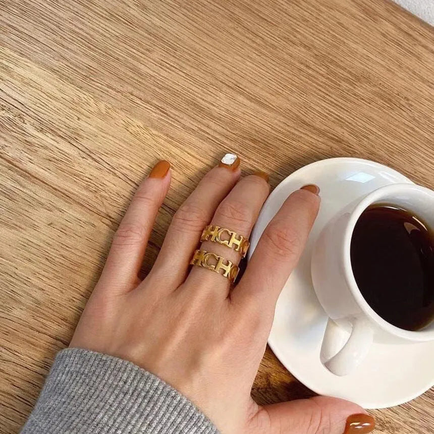 Gold titanium steel unisex letter ring with hollowed cut design, sizes 6 to 9