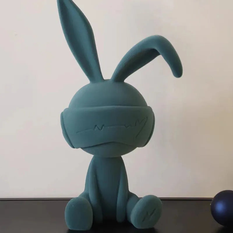 Suede blindfold rabbit resin table ornament in blue, green, or red colour.