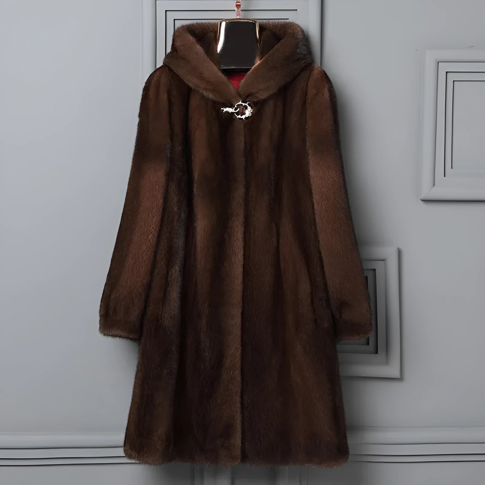 Women's long black faux fur hooded coat for winter street fashion.