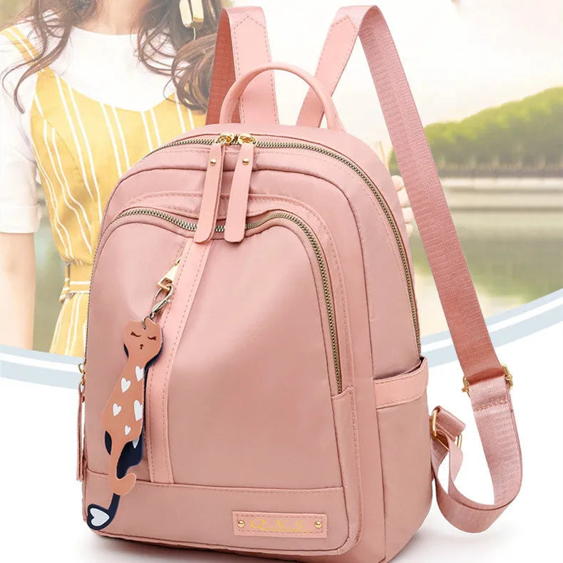 Black casual nylon backpack with shoulder straps, showing internal organiSation pockets and a soft handle.