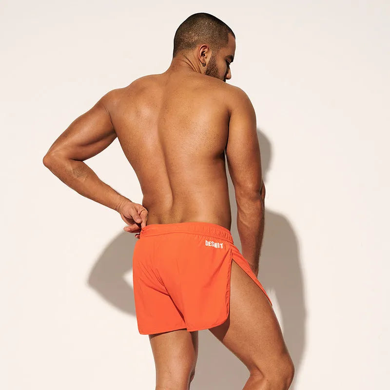 Men's loose beach shorts in polyester available in orange, green, and black colours