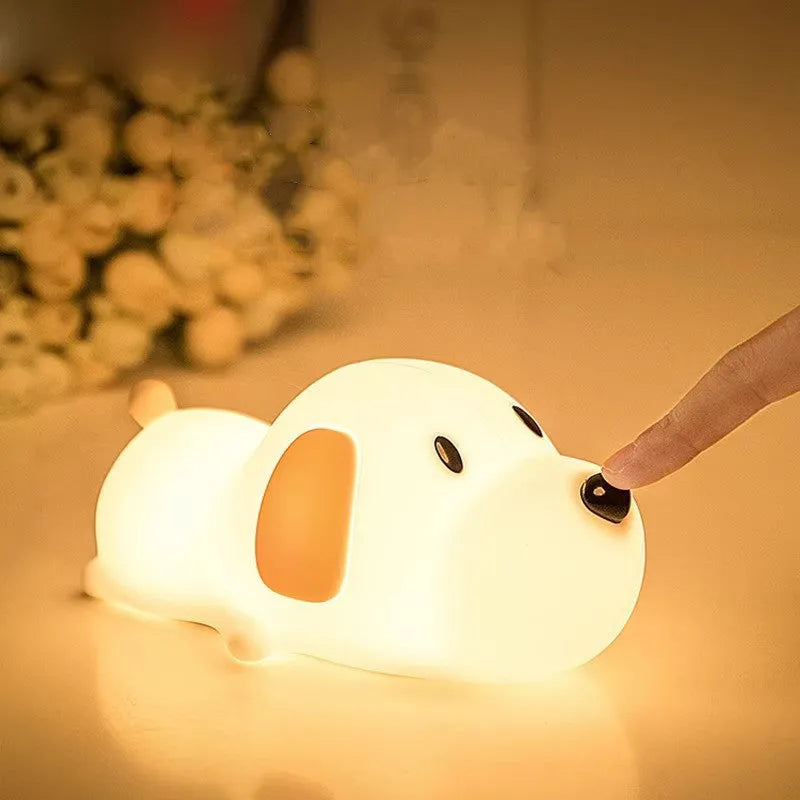 Cartoon dog design USB-charging silicone night lamp in two colours on a surface.