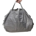 Mini reusable compact grocery bag in light blue, folded and open, made from water-repellent nylon cloth.