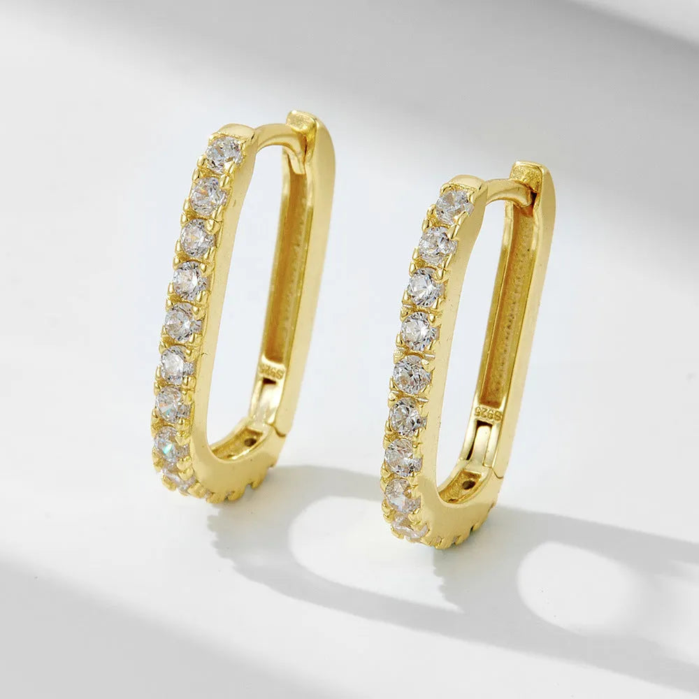 A pair of oval geometric sterling silver ear clips with zircon stones in white or yellow colour.