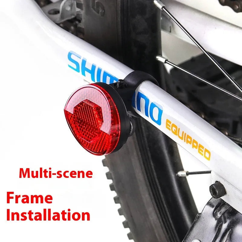 Plastic bicycle taillight with anti-theft bracket mounted on seat post showing red reflective panel