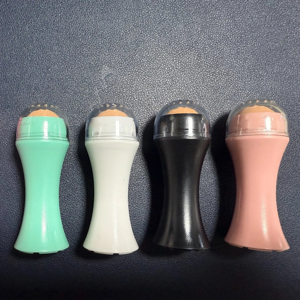 Volcanic stone facial roller for oily skin control in black, green, pink, or white.