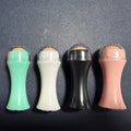 Volcanic stone facial roller for oily skin control in black, green, pink, or white.