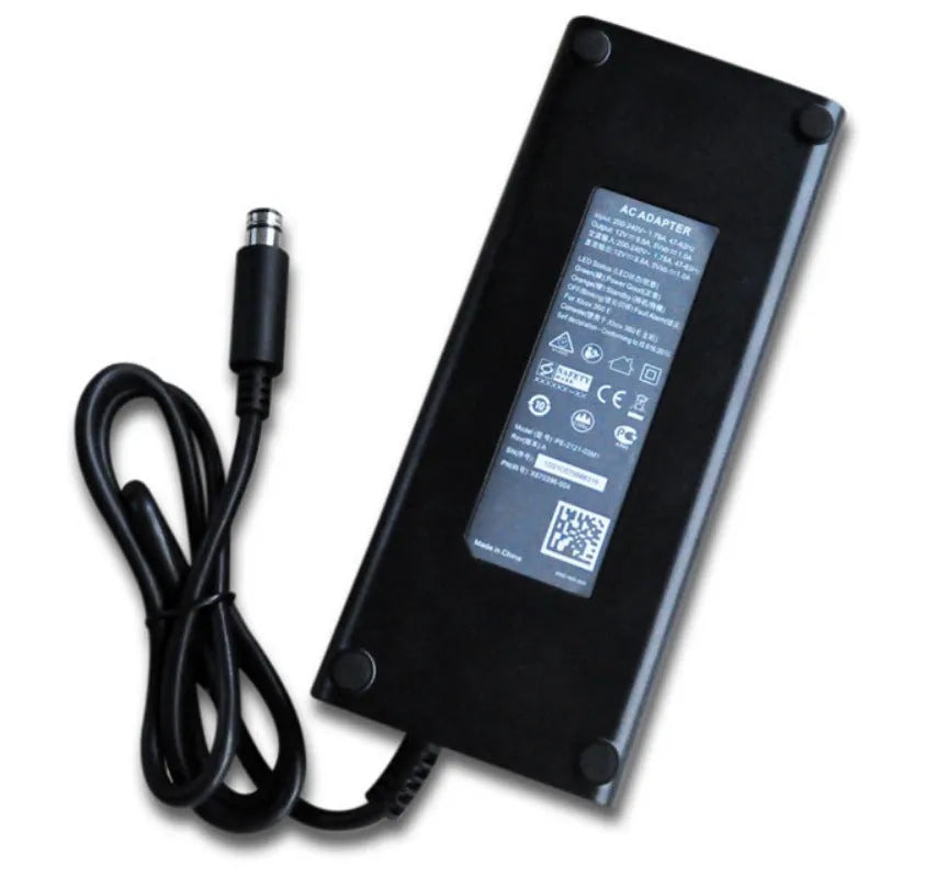 Black Xbox 360 E console AC power adapter with plug options for EU, UK, and US sockets.