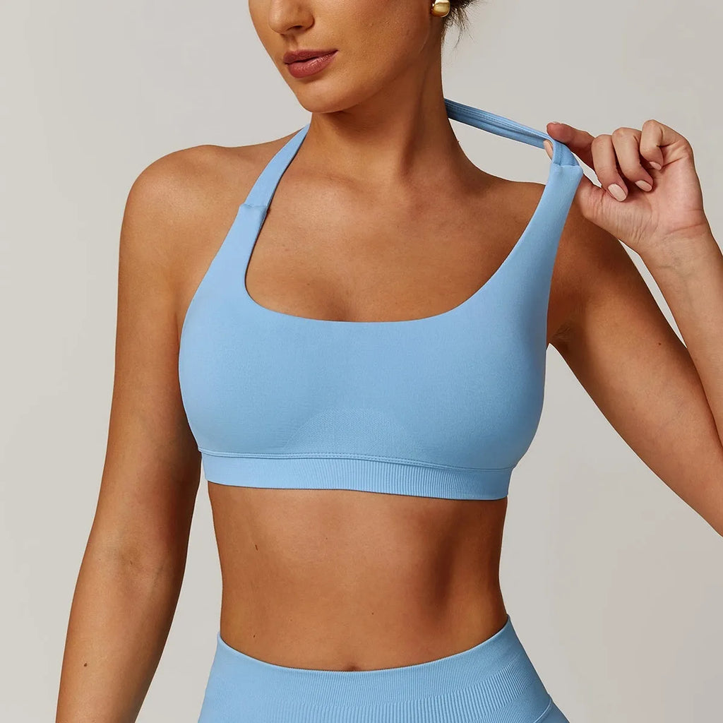 Women's black halter neck sports bra with adjustable back closure, shown from front and back.
