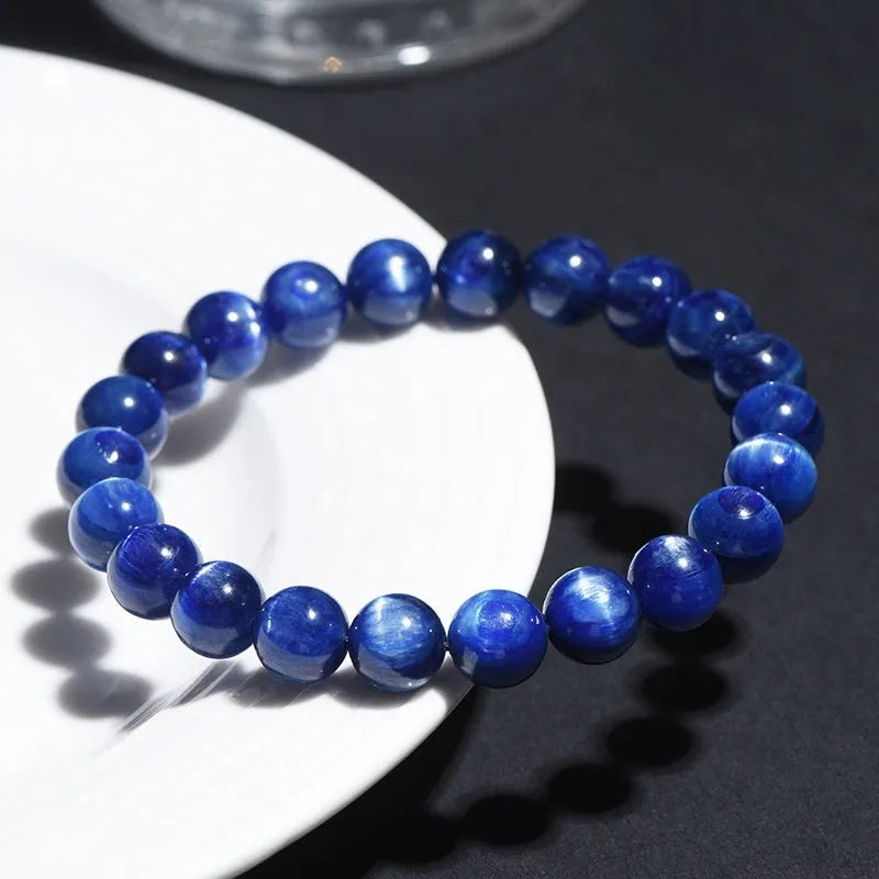 A polished blue crystal bracelet with geometry-shaped beads and a Ruyi charm on a single circle.
