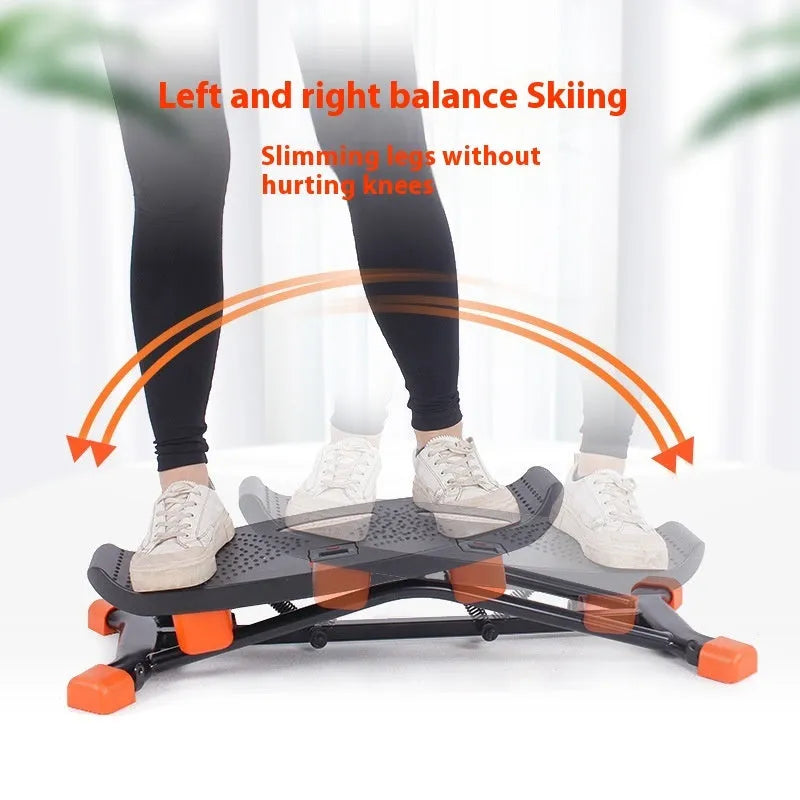 Black mini indoor skiing exercise machine with elastic hand straps, compact home cardio equipment.