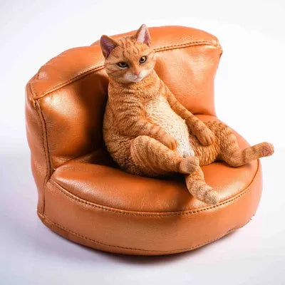 Small resin cat figurine on a sofa, a 1:6 scale car dashboard ornament.