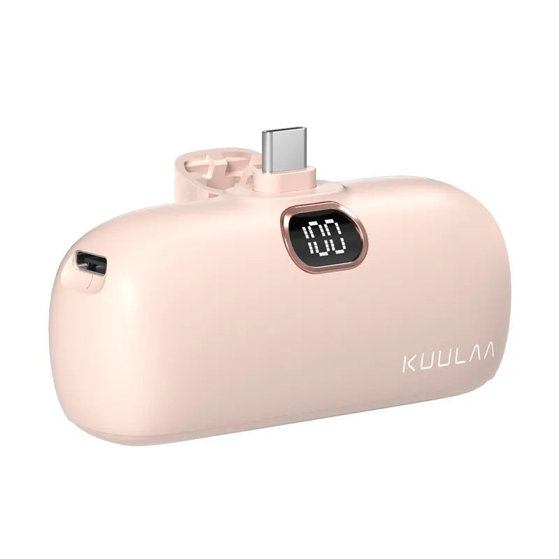 Compact cylindrical alloy power bank with built-in charging cable and LCD digital display.