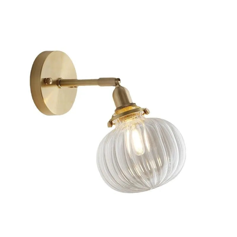 Creative pumpkin-shaped wall lamp with a textured water ripple glass shade mounted on a white wall