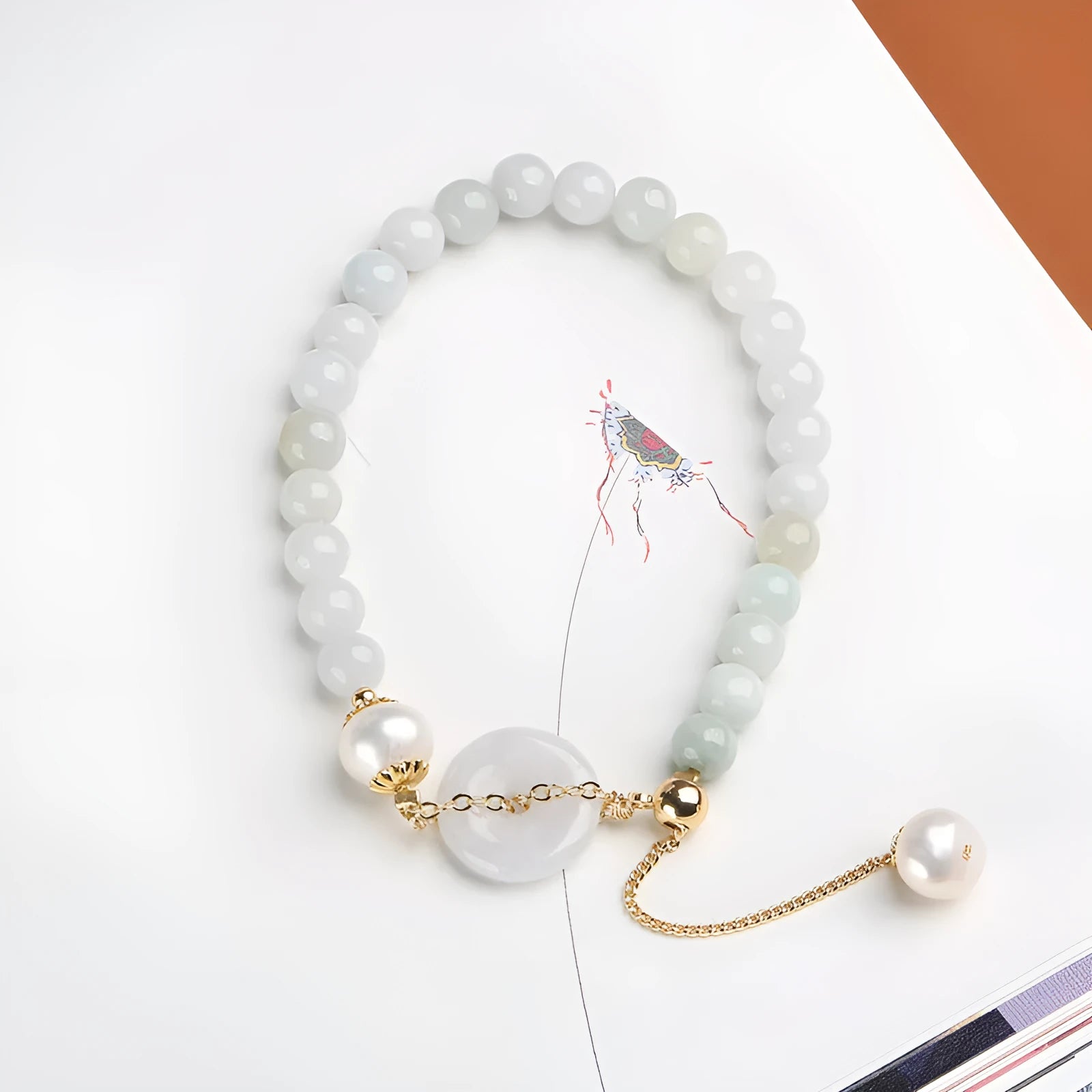 Jade green pearl bracelet with peace buckle fastening and round geometric pendant for women