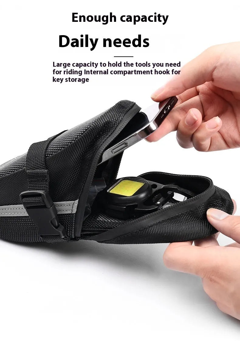 Black quick release bicycle saddle bag mounted under a bike seat