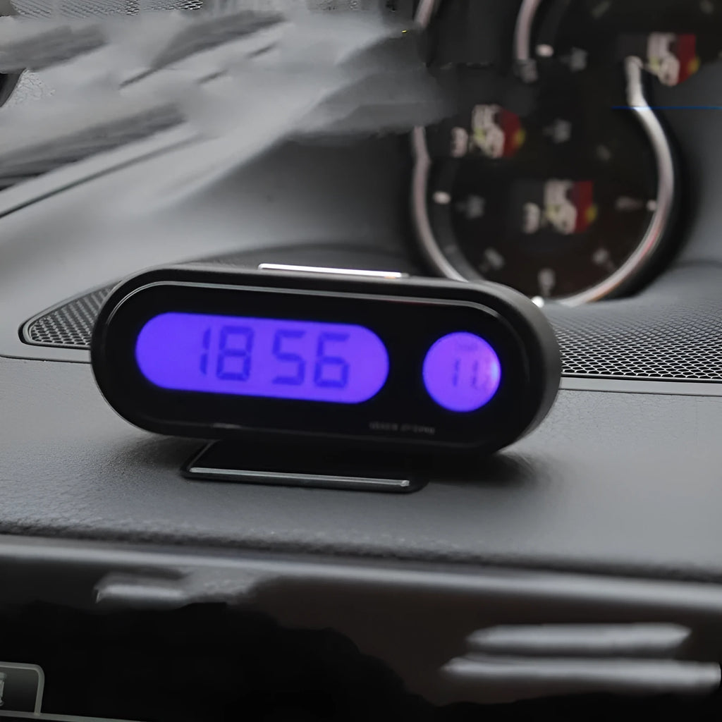 Black digital LED car clock and thermometer with adjustable mounting bracket on a dashboard.
