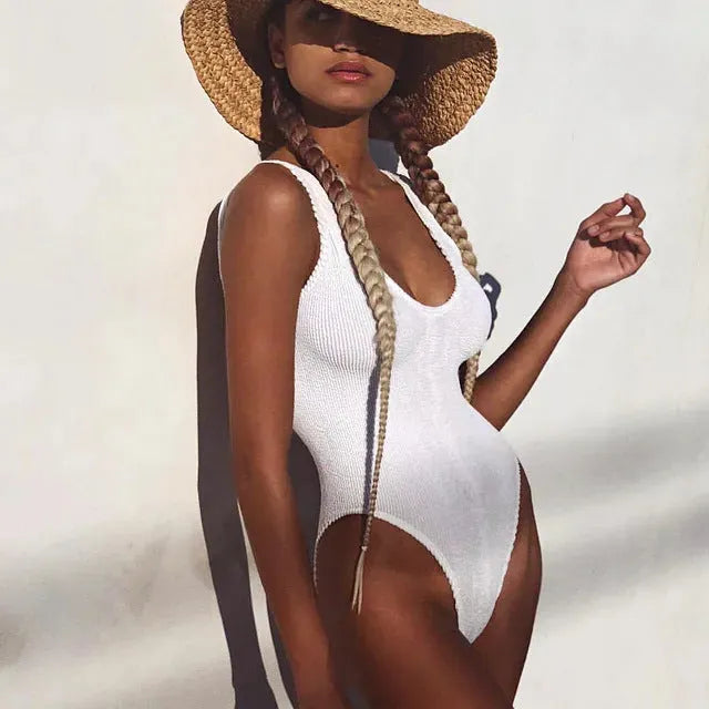 Women's solid colour seersucker one-piece swimsuit in a backless, sleeveless design