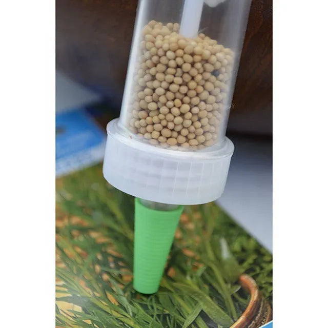 Plastic mini garden seeder tool measuring 12cm long for precise seed planting in pots