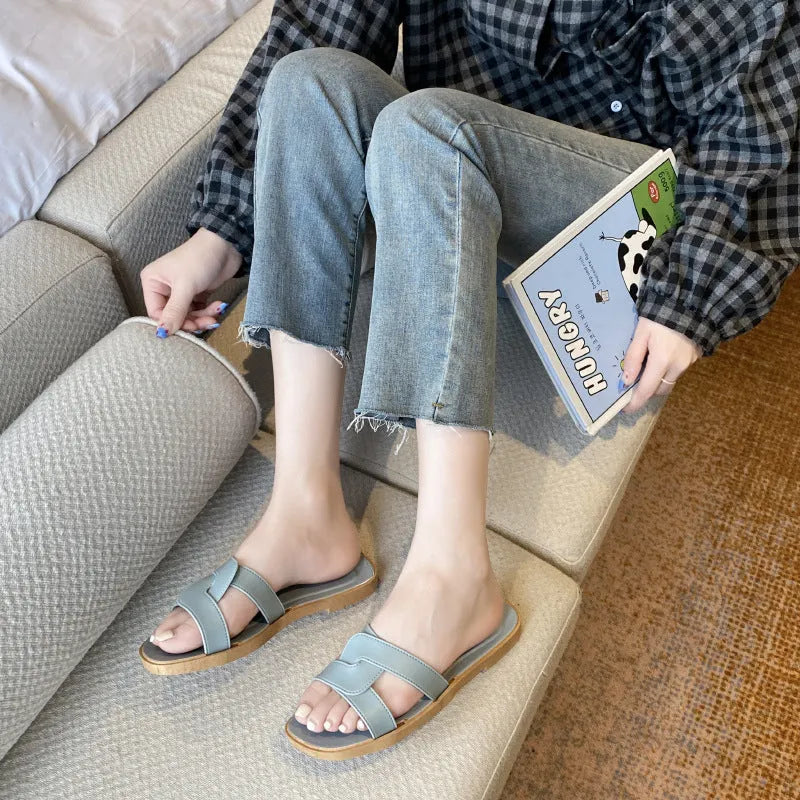 Women's PVC cross-strap flip flop sandals in light blue on a plain background.