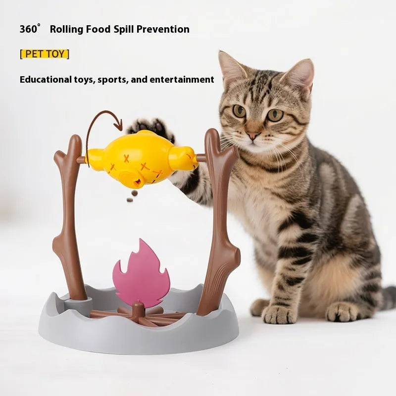 Barbecue-themed plastic tumbling cat treat feeder toy on a floor.
