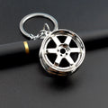 Zinc alloy car wheel hub keychain in gold, silver, and black colour options.