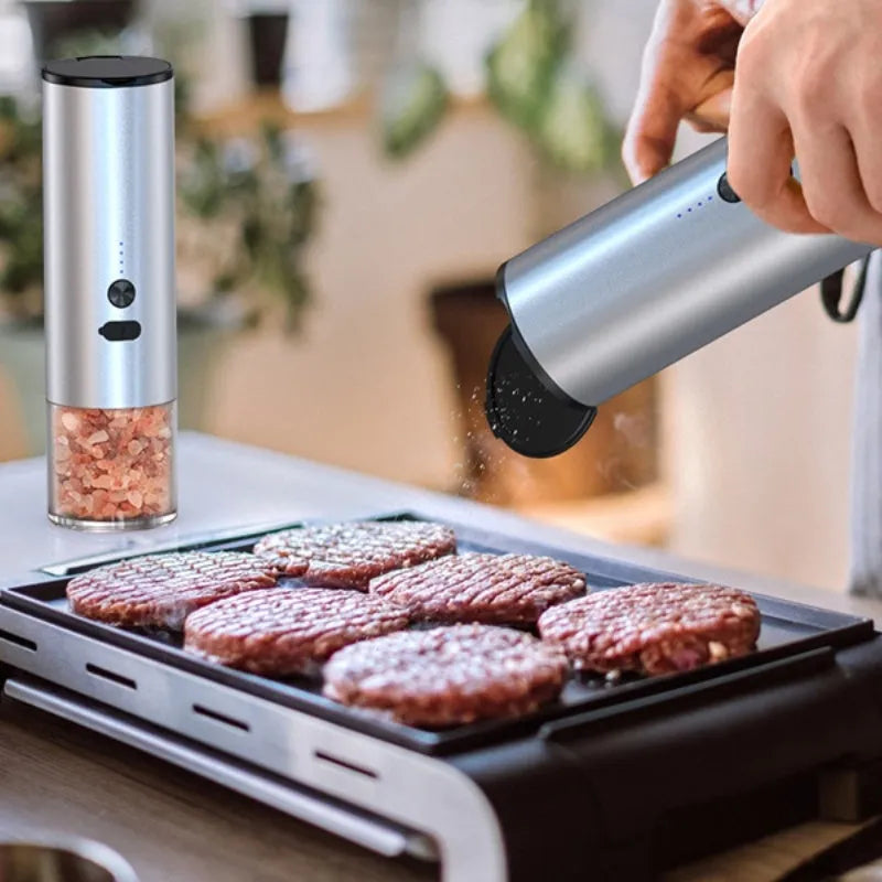 White and black electric salt and pepper grinders with USB port and clear glass jars.