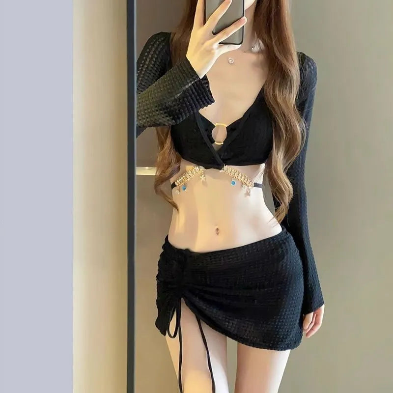 Women's long sleeve black bikini swimsuit with hot spring split style, made from polyester.