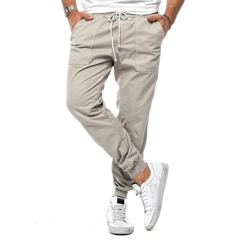 Men's loose tapered casual trousers with drawstring waist and ankle bands in solid colour